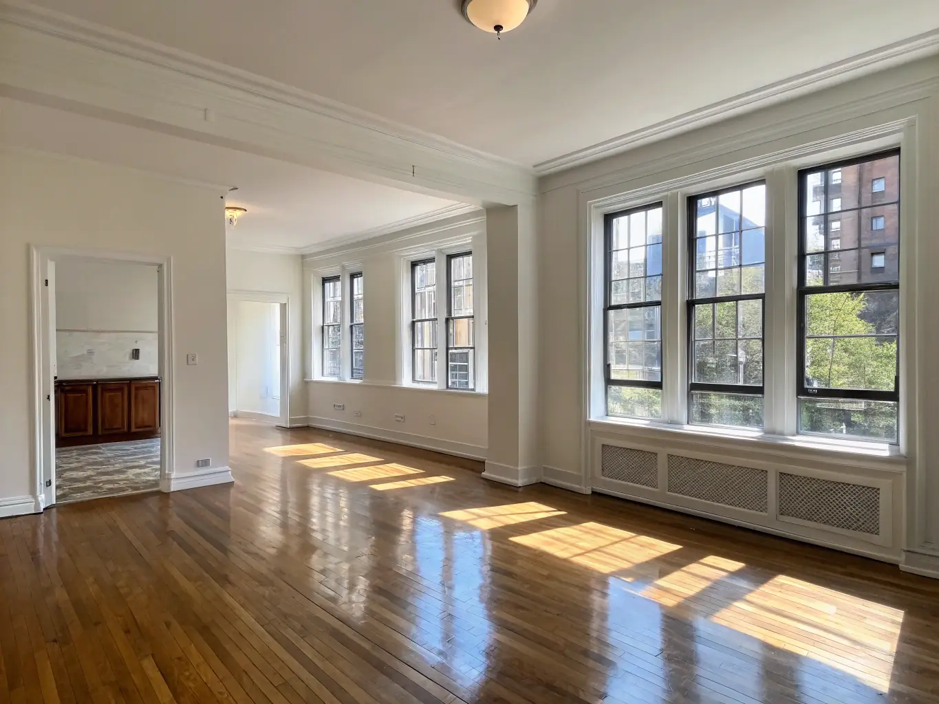 A sparkling clean apartment living room after an end-of-lease cleaning, showcasing spotless floors and windows, ready for inspection.